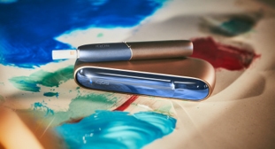A blue and coppery IQOS 3 device.