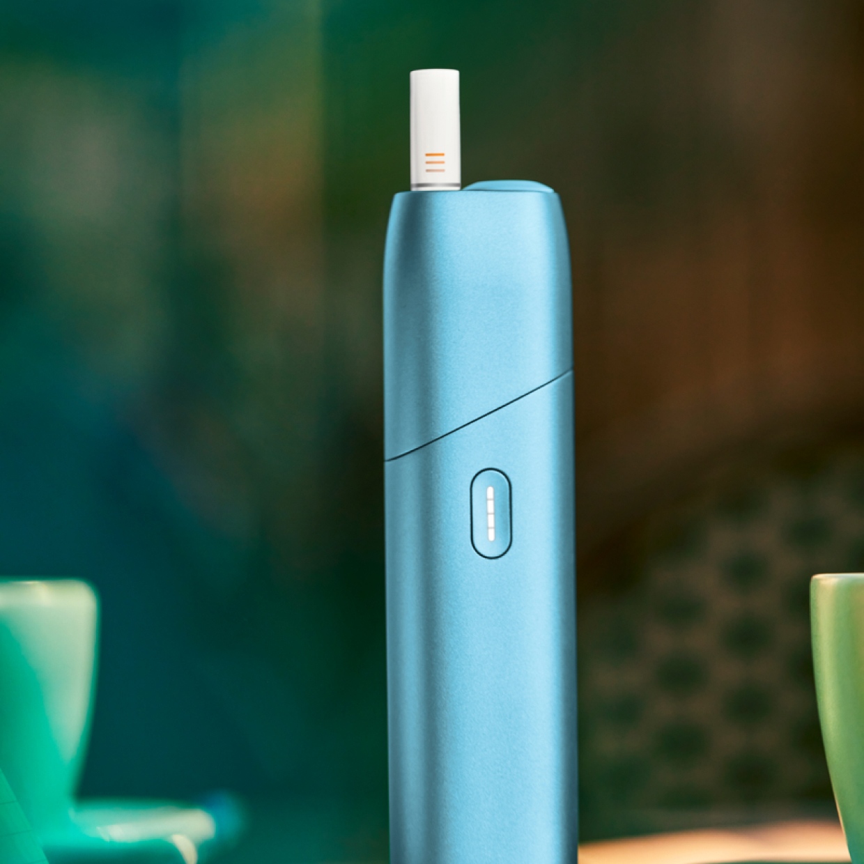 Turquoise IQOS Originals ONE heated tobacco device with HEETS Stick.