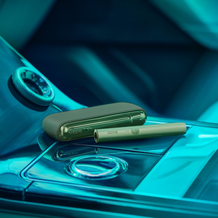 An IQOS ILUMA Pocket Charger and Holder on a DJ's turntable.